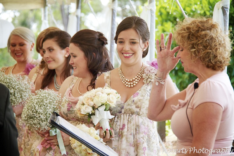 Bridesmaids smiling during wedding ceremony - wedding photography sydney